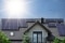 The picture shows collectors on a residential house as a symbol for the combination of heat pump and solar thermal energy.